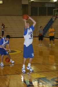 RUNS IN THE FAMILY: Robert Kitzinger, basketball player and junior, takes a shot during practice. Like his dad, Robert has become a standout basketball player, but has developed his own style of play. NICK JOHNSON / PHOTO