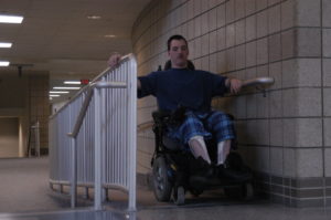 ROLL OUT: Senior Mike Davis rolls up the ramp at the end of SRT on his way to his next class. Although physically disabled students have ramps available for easier movement around the school, they are not always immediately accesible. JINNY ZHANG/ PHOTO 