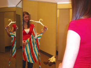 DRESSING SMART: Sophomore Allison Scott views a dress in a mirror. Scott usually shops at discount stores instead of more expensive places. SHIRLEY CHEN / PHOTO