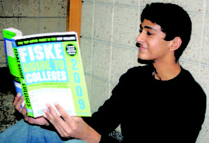 BOOK IT: Freshman Mihir Kumar reads a college handbook. Instead of relying on recruting, he said he prefers to find colleges on his own. NICK JOHNSON / PHOTO