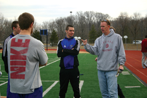 DIRECTIONAL ADVICE: Will Ellery, new track and field head coach, talks with seniors (from right) Dean Weaver, Michael Spahn and Joseph "Joe" Rippe during practice. This is Ellery's first head coaching job here, replacing longtime coach Chuck Koeppen.