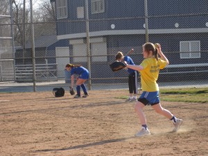 BACK TO THE DIAMOND: Varsity softball players work on throwing mechanics during practice. The team began practicing fundamentals in February. KATE GRUMME / PHOTO
