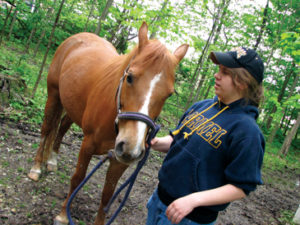 HORSING AROUND: Senior Avery Sanders takes her horse outside to give it some fresh air. According to Sanders, owning a horse is not all fun and games because it takes a large amount of work to take care of this less common pet, although she said that it is worth the effort. POOJA MATHUR / PHOTO